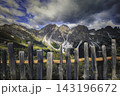 Mountain landscape with rocky peaks and wooden railing 143196672