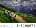 Mountain landscape with wooden bench and alpine valley 143196674