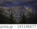 Mountain landscape with rugged peak and dark clouds 143196677