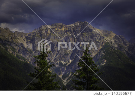 Mountain landscape with rugged peak and dark clouds Mountain landscape with rugged peak and dark clouds 143196677