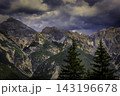 Dramatic alpine mountain range beneath storm clouds 143196678