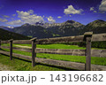 Alpine mountain panorama behind a rustic wooden fence 143196682