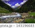 Alpine mountain valley with a rushing mountain stream 143196683