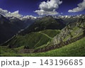 Alpine mountain valley beneath a dramatic sky 143196685