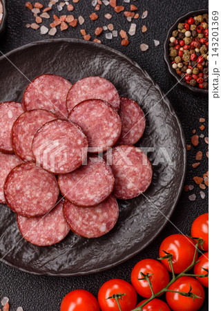 Sliced salami sausage, smoked meat as a delicacy for the table. Salami sausage Sliced salami sausage, smoked meat as a delicacy for the table. Salami sausage 143201369