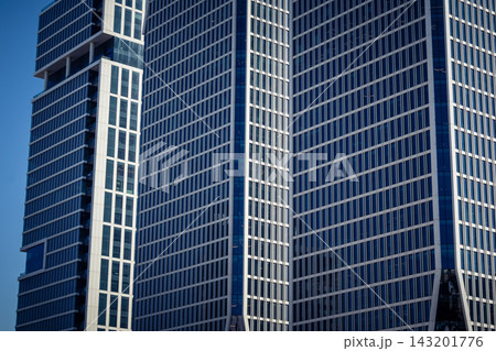 Vertical architectural perspective of modern glass skyscrapers in the metropolitan district Vertical architectural perspective of modern glass skyscrapers in the metropolitan district 143201776