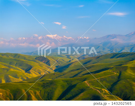 Panoramic View of Green Hills and Snow-Capped Mountains Panoramic View of Green Hills and Snow-Capped Mountains 143202565