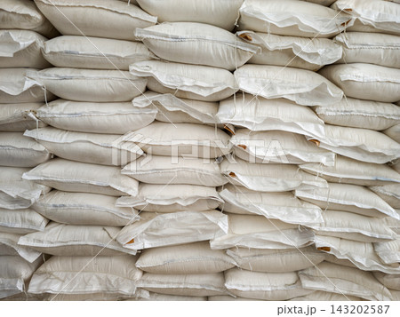 Close-up of stacked white woven sacks in geometric pattern Close-up of stacked white woven sacks in geometric pattern 143202587