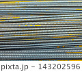 Stack of Metal Rebar Rods with Yellow Markings 143202596