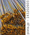 Close-Up of Steel Rebar Pile with Yellow Coating 143202603