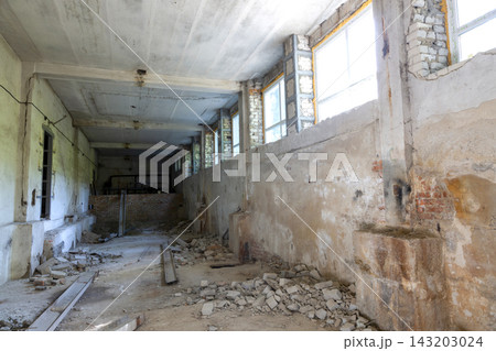 Broken floor, trash and clutter in an abandoned room 143203024