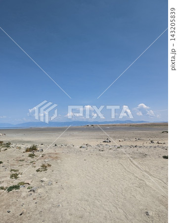 Expansive view of the Great Salt Lake shoreline under a bright blue sky. 143205839