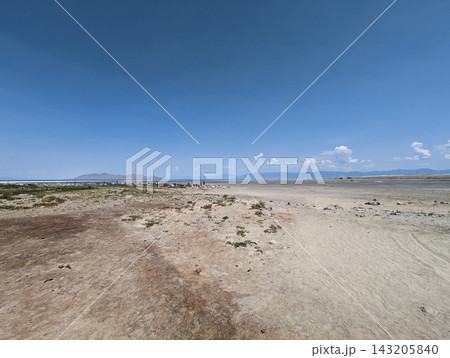 Expansive view of the Great Salt Lake shoreline under a bright blue sky. Expansive view of the Great Salt Lake shoreline under a bright blue sky. 143205840