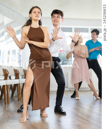 Dancing in a dance studio - couple in festive clothes learning to dance foxtrot 143206653