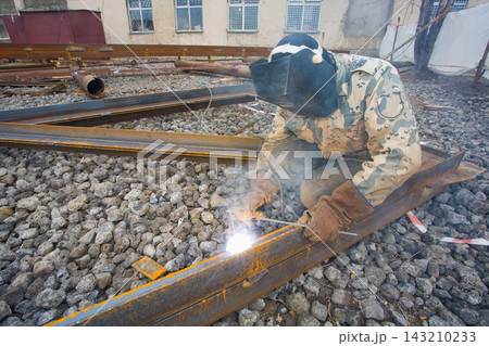 Welder in mask welding metal construction on open air. 143210233