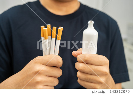 Man holding electronic cigarettes, no smoking. 143212079