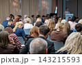 Seminar participants seen from behind in seated rows 143215593