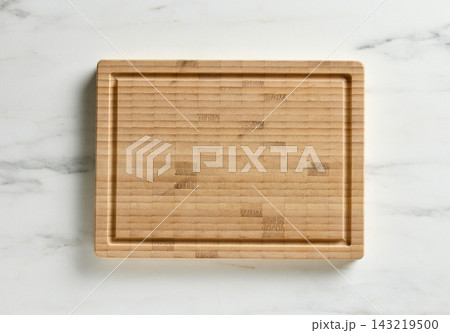 new empty wooden cutting board on white marble kitchen table top background 143219500