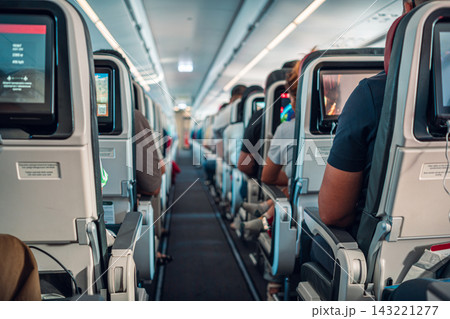 Passengers Seated Inside Airplane Cabin 143221277