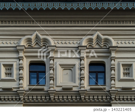 Ornate Historic Building Facade With Decorative Windows and Architectural Detail in Classical Style Ornate Historic Building Facade With Decorative Windows and Architectural Detail in Classical Style 143221405