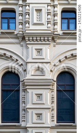 Ornate Historic Building Facade With Decorative Windows and Architectural Detail in Classical Style Ornate Historic Building Facade With Decorative Windows and Architectural Detail in Classical Style 143221406