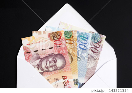 Botswana pula in a white envelope on a black background 143221534