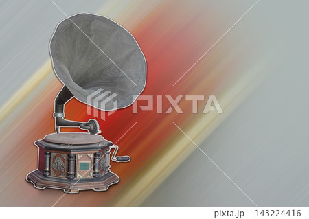 side view antique and old brass and wood gramophone placed on a white edge, set against a red and yellow speed and laser and gray background, decor, object, ancient, copy space 143224416