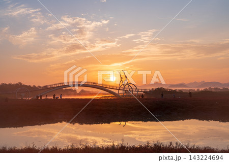 Sunrise Dawn over Misaeng Bridge with Water Reflection in Siheung Wetland, South Korea 143224694