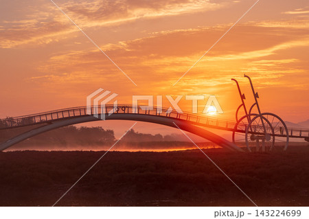 Sunrise Dawn over Misaeng Bridge with Water Reflection in Siheung Wetland, South Korea 143224699