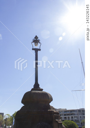 It is a vintage streetlamp bathed in sunlight. It is a vintage streetlamp bathed in sunlight. 143226145