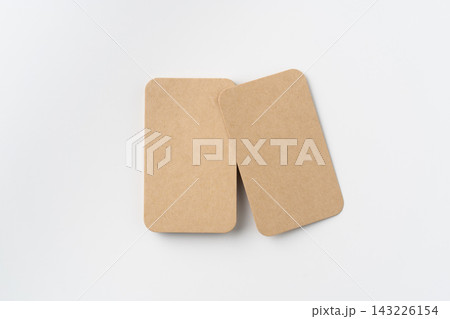 Top view of two blank kraft paper rounded corner business cards isolated on white background with copy space Top view of two blank kraft paper rounded corner business cards isolated on white background with copy space 143226154