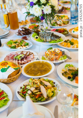 Variety of food served on multiple plates during a celebratory event Variety of food served on multiple plates during a celebratory event 143226705