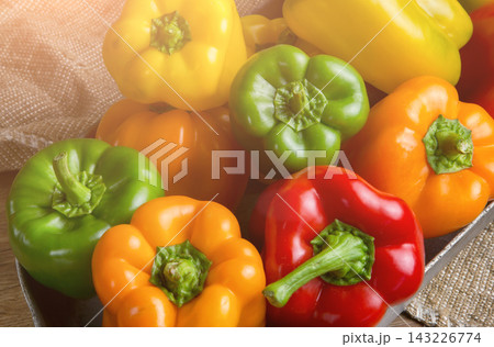 Red, green and yellow sweet bell peppers on table, Red, green and yellow sweet bell peppers on table, 143226774