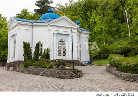 Small white pavillion topped with a blue dome nestled in a green park, Zheleznovodsk Small white pavillion topped with a blue dome nestled in a green park, Zheleznovodsk 143226812