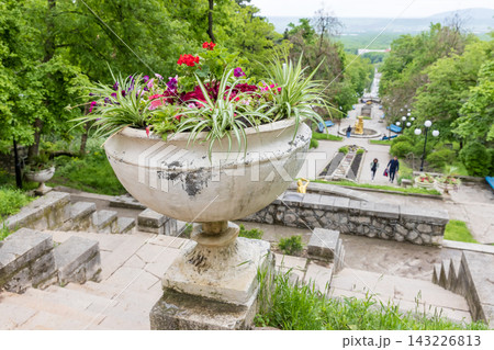 Ornamental stone planter filled with colorful flowering plants at Cascade Staircase Ornamental stone planter filled with colorful flowering plants at Cascade Staircase 143226813