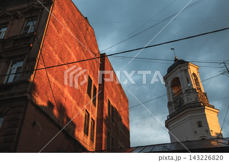 Historic clock tower of Vyborg old town rises beside a red brick building Historic clock tower of Vyborg old town rises beside a red brick building 143226820