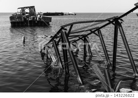 Black and white photo of a rusted metal structure in Battery bay, Russia Black and white photo of a rusted metal structure in Battery bay, Russia 143226822
