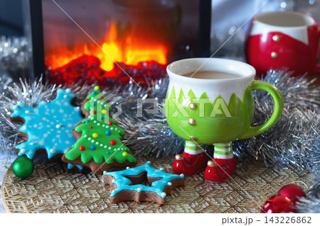 gingerbread cookies and a cup of hot chocolate. A view through a snowy window gingerbread cookies and a cup of hot chocolate. A view through a snowy window 143226862