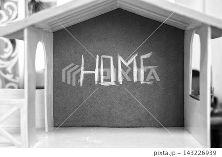the inscription House on a brown wall with white paint 143226939