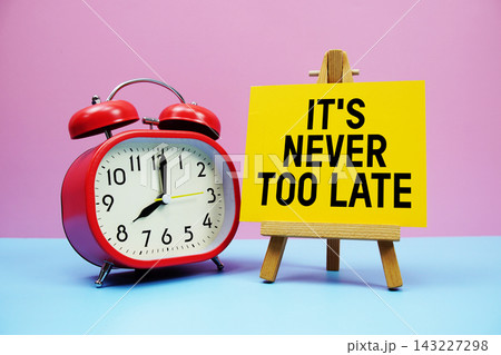 It's Never Too Late text with alarm clock on pink and blue background 143227298