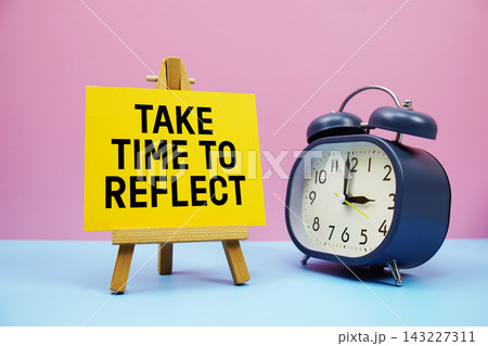 Take Time To Reflect text with alarm clock on pink and blue background Take Time To Reflect text with alarm clock on pink and blue background 143227311