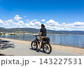 Summer sports leisure activity. Adult man on a bicycle by the lake on a sunny summer day 143227531