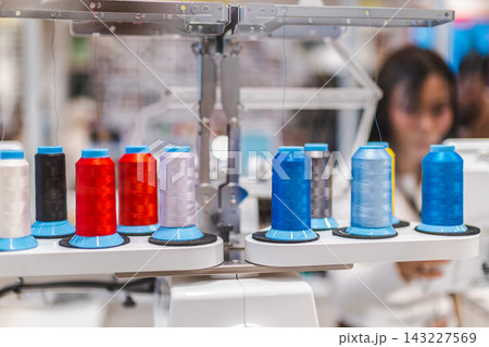 Colorful Thread Spools on Industrial Textile Machinery 143227569