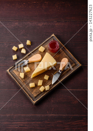 Hard aged Parmesan cheese in blocks and cubes for home cooking. Parmesan cheese 143227623