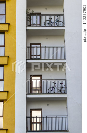 Modern apartment building balconies with parked bicycles Modern apartment building balconies with parked bicycles 143227903