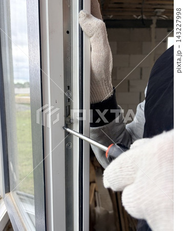 Manual adjustment of a new window in a newly built apartment. Manual adjustment of a new window in a newly built apartment. 143227998