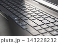 Close up of laptop keyboard keys. remote work and technology concept 143228232