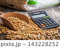 Wood Pellets And Calculator On Table Representing Biofuel Heating Costs And Renewable Energy Budgeting 143228252