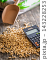 Wood Pellets And Calculator On Table Representing Biofuel Heating Costs And Renewable Energy Budgeting 143228253