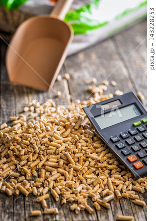 Wood Pellets And Calculator On Table Representing Biofuel Heating Costs And Renewable Energy Budgeting Wood Pellets And Calculator On Table Representing Biofuel Heating Costs And Renewable Energy Budgeting 143228253